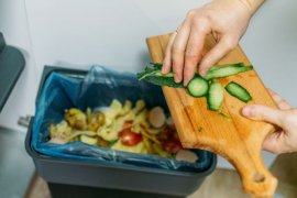 Person throwing out food waste.