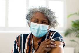 Happy senior African American woman wearing face mask.