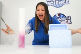 Girl doing experiments in front of Mad About Science background
