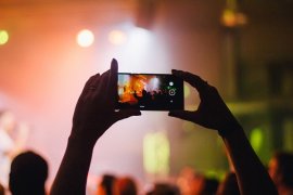 Person taking a photo at a concert. 