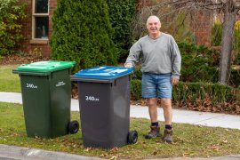 Resident putting out waste bins