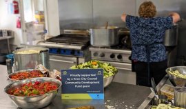 Woman preparing food and a sign stating Proudly supported by a Knox City Council Community Development Fund grant.