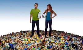 Male and female standing on a fake mound of rubbish