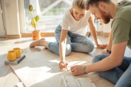 Two people looking at building plans.