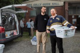 Rory Seedsman (right) doing his washing at Foothills Community Care.