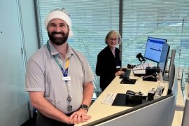 Two Knox City Council staff members standing at a customer service desk