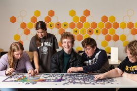 Young people doing a jigsaw puzzle in the Youth Hive