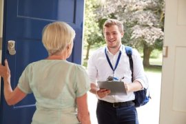 Man asking a woman questions at her front door