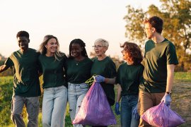 A group of people holding rubbish bags