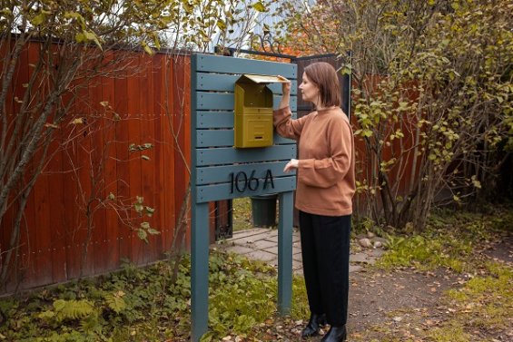 Woman checking her letterbox