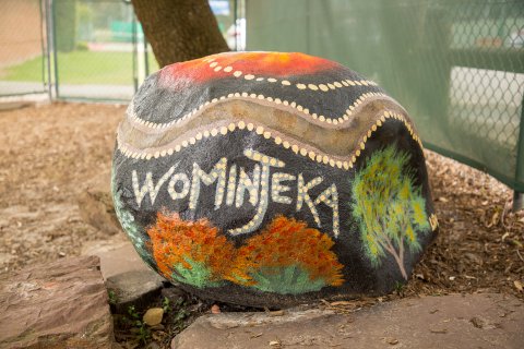 Drum decorated with spot painting and word Wominjeka