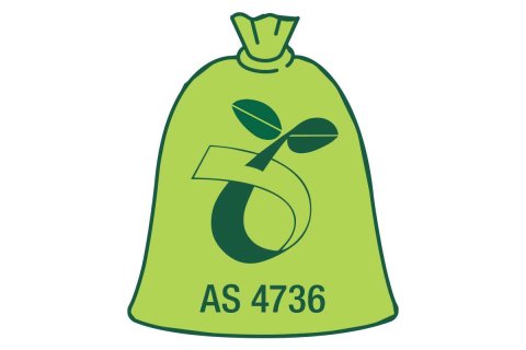 Lime green compostable caddy liner with the seedling symbol and code AS4736