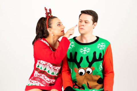 Two people in Christmas jumpers